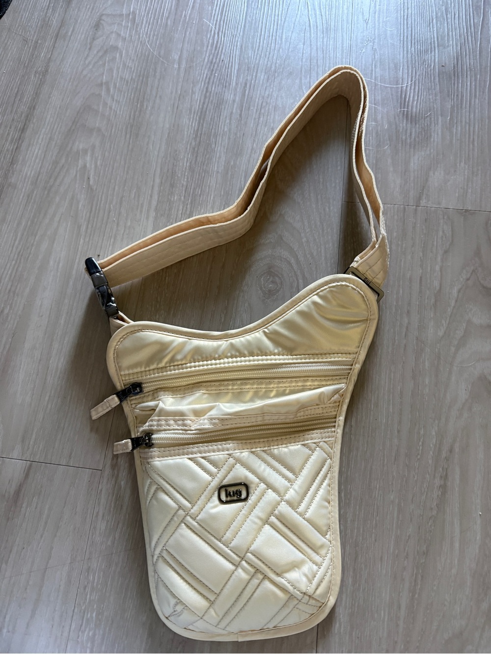 NWT Lug Slingshot Crossbody or Waist Bag, metallic shiny gold color.